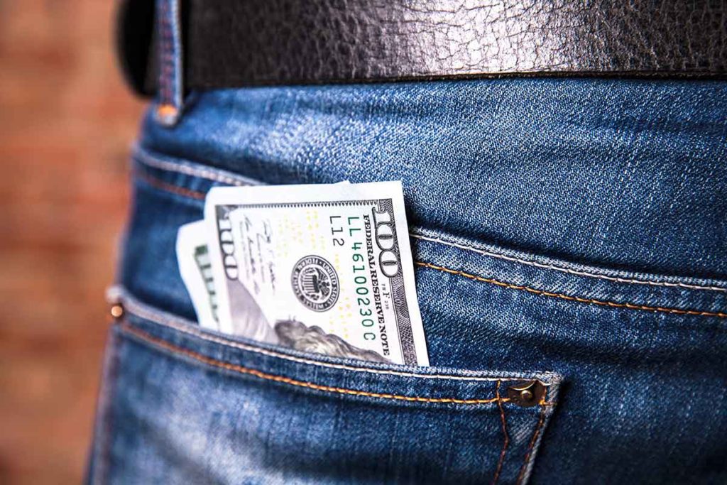 showing dollars in jean pocket
